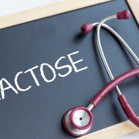 Small chalkboard with `Lactose`written on it and stethescope