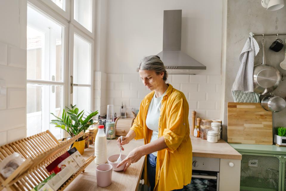 Woman in the kitchen making cereal