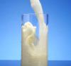Milk being poured into a tall glass