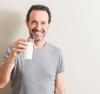 Senior man holding a glass of milk