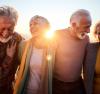 Four laughing elderly people outdoors