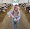 A dairy farmer pouring milk into a glass