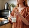 young woman drinking milk with a bamboo straw