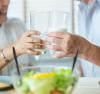2 people holding a glass of milk each