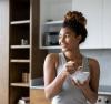 Woman eating a bowl of yogurt